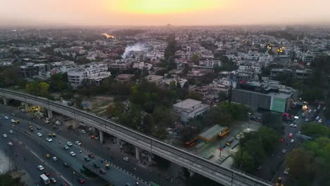 4K-Drone-Shots-of-a-Sunset-in-an-Indian-City-New-Delhi-above-trees-and-houses-beautiful-light-punjabi-bagh-club-posh-colony