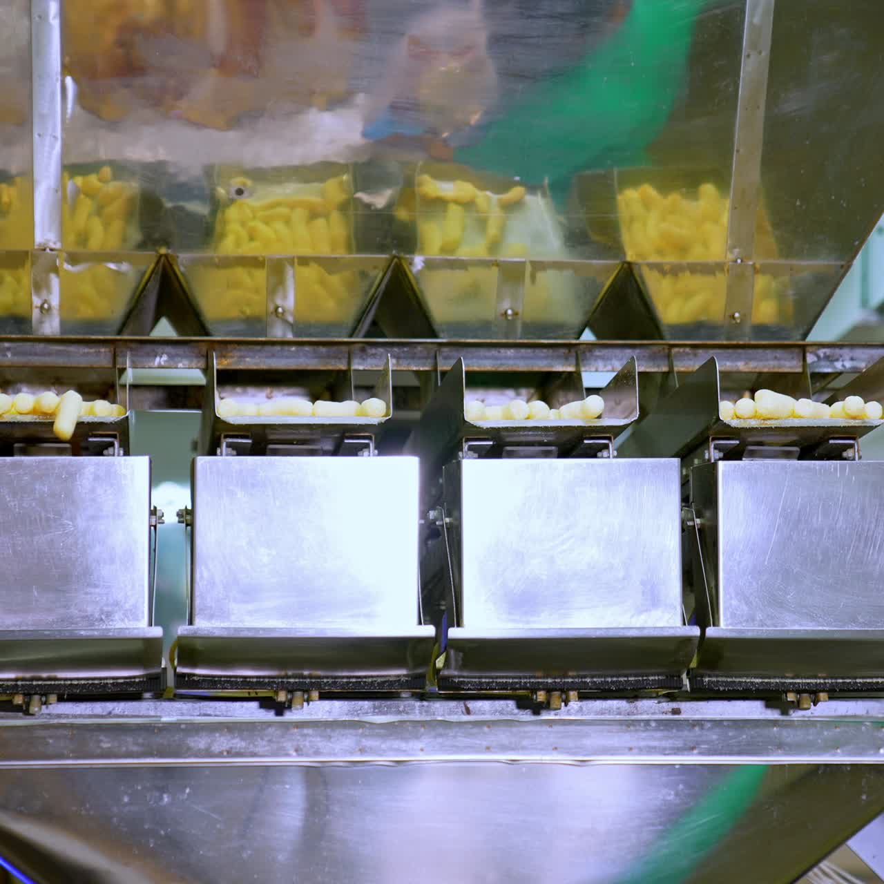 Factory conveyor full of crispy puffcorn. Corn sticks factory making