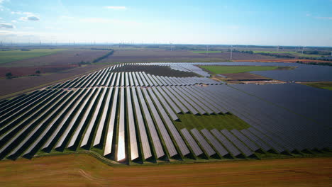 massive solar power plant on sunny day in poland - aerial panning