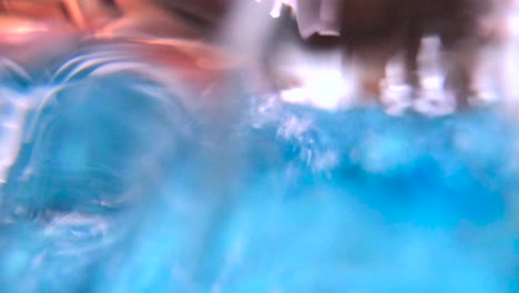 active young child learning to swim pov above - underwater in public swimming pool