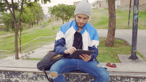 young boy using tablet outdoors