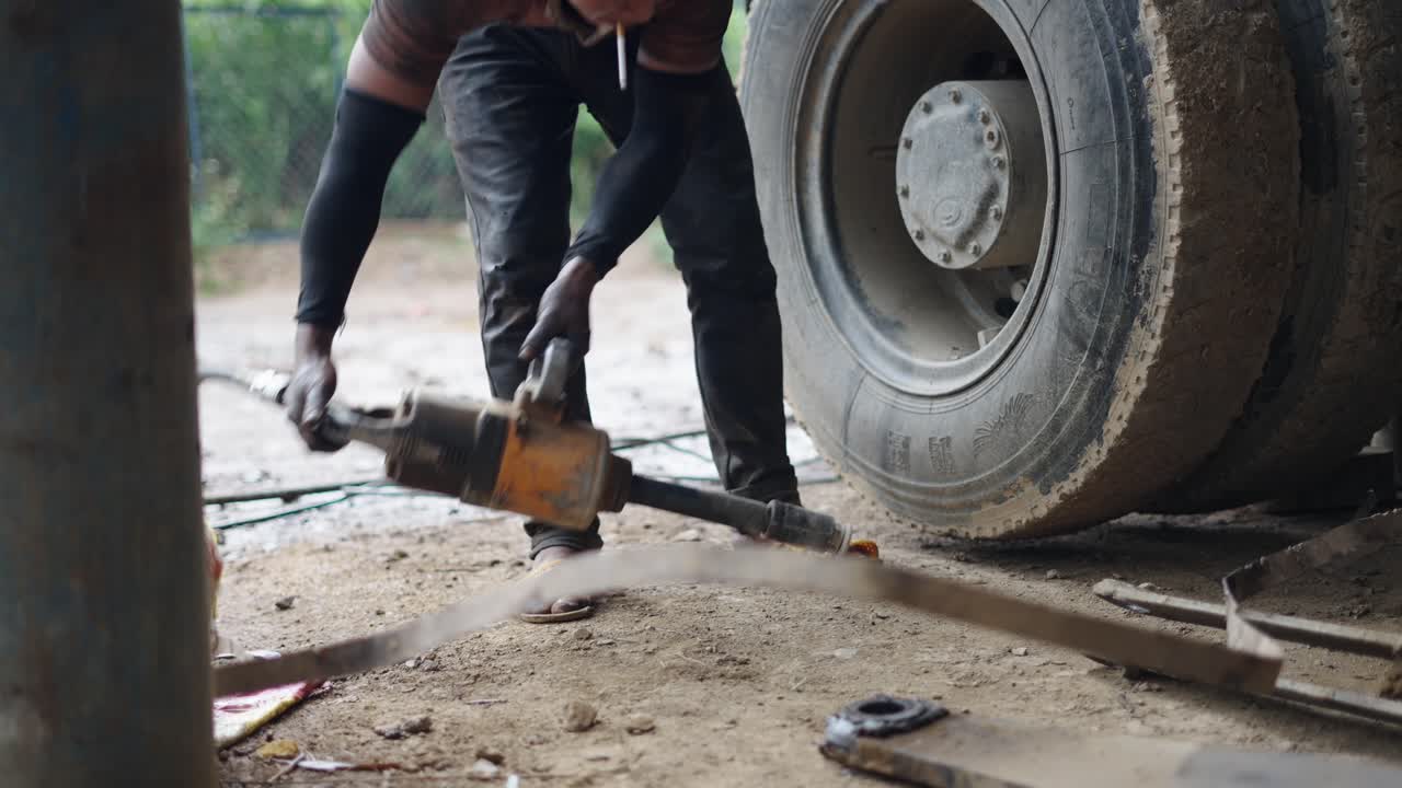 Truck Mechanic Working on a Truck Tire