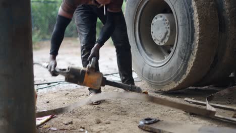 Truck Mechanic Working on a Truck Tire