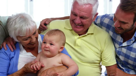 a happy family is looking the baby