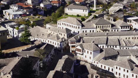 Houses-of-Gjirokastra-white-walls-and-grey-stone-tiled-roofs-alongside-narrow-alleys