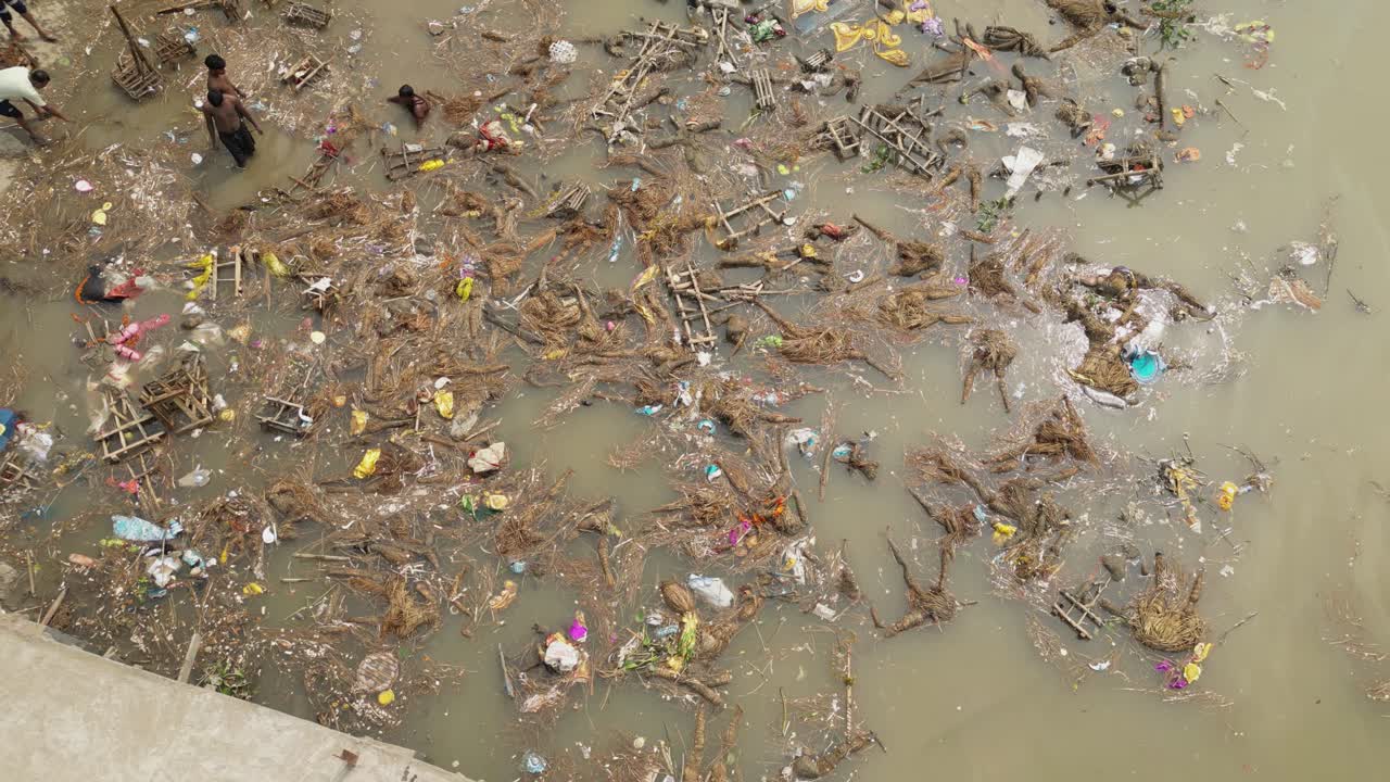 Drone shot of garbage in ganga river due to idol immersion, garbage polluting river water