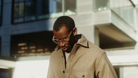 man looking at his phone in the city