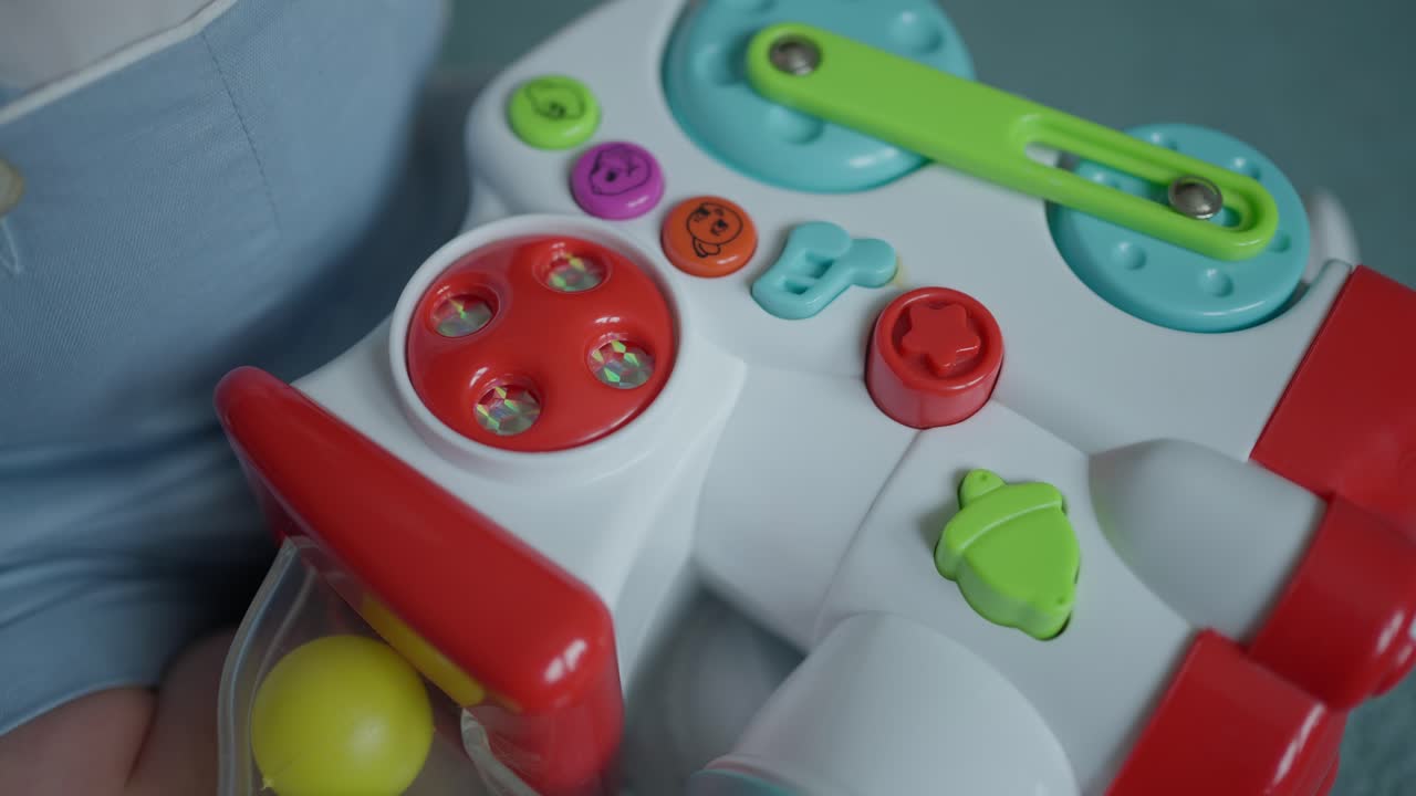 Primo piano della mano di un bambino con un giocattolo educativo colorato, che si concentra sull'esplorazione tattile e giocosa