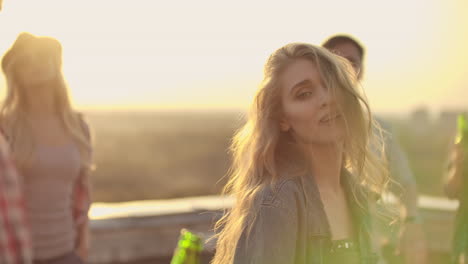 Dancing-girl-rooftop-party-slow-motion-group-of-multiracial-friends-hanging-out-young-asian-woman-dancing-enjoying-roof-top-event-at-sunset-drinking-alcohol-having-fun-on-weekend-celebration