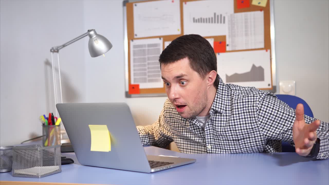 Man looking at laptop in office