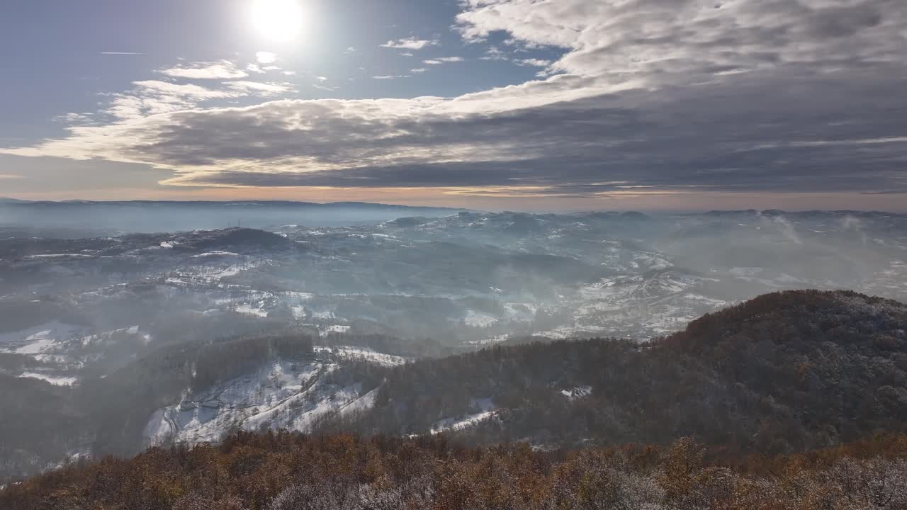 An awe-inspiring aerial shot of snow-covered mountains, showcasing the serene beauty of winter from above. Perfect for nature and adventure projects.