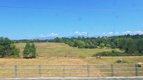 lush landscapes and fields viewed from a train