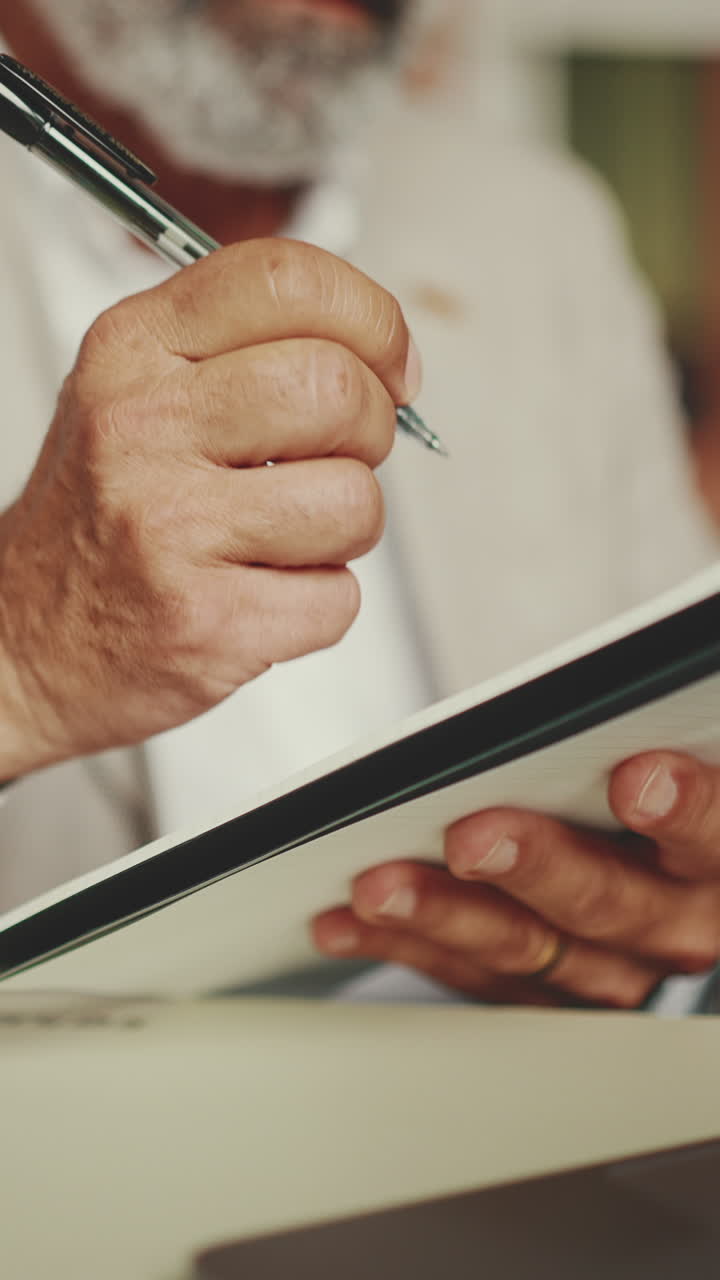 Person Writing in Notepad
