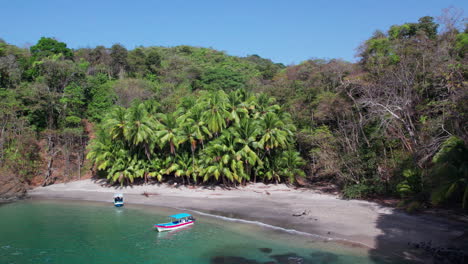 slow establishing shot of small boats anchored at a beach in cebaco island