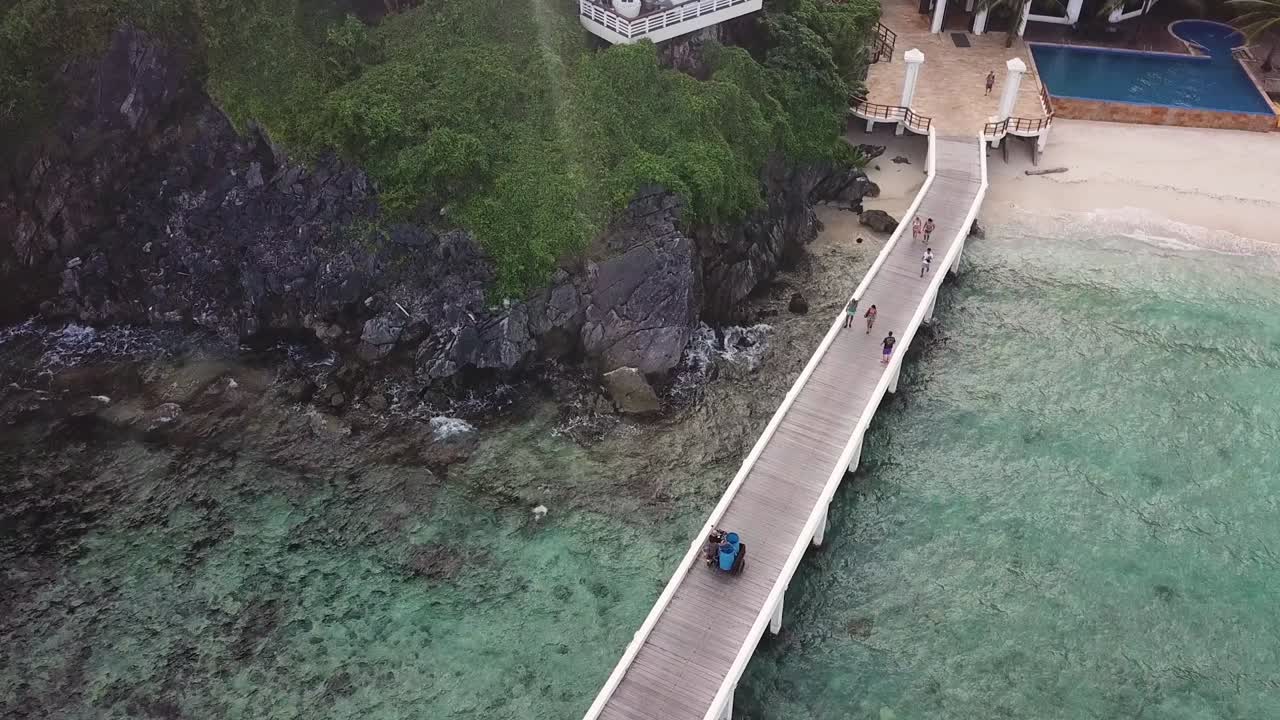 Aerial View of Pier, Traditional Boats and Helidrom on Exotic Tropical Beach of El Nido, Palawan Island Archipelago, Philippines