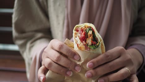 woman eating a wrap