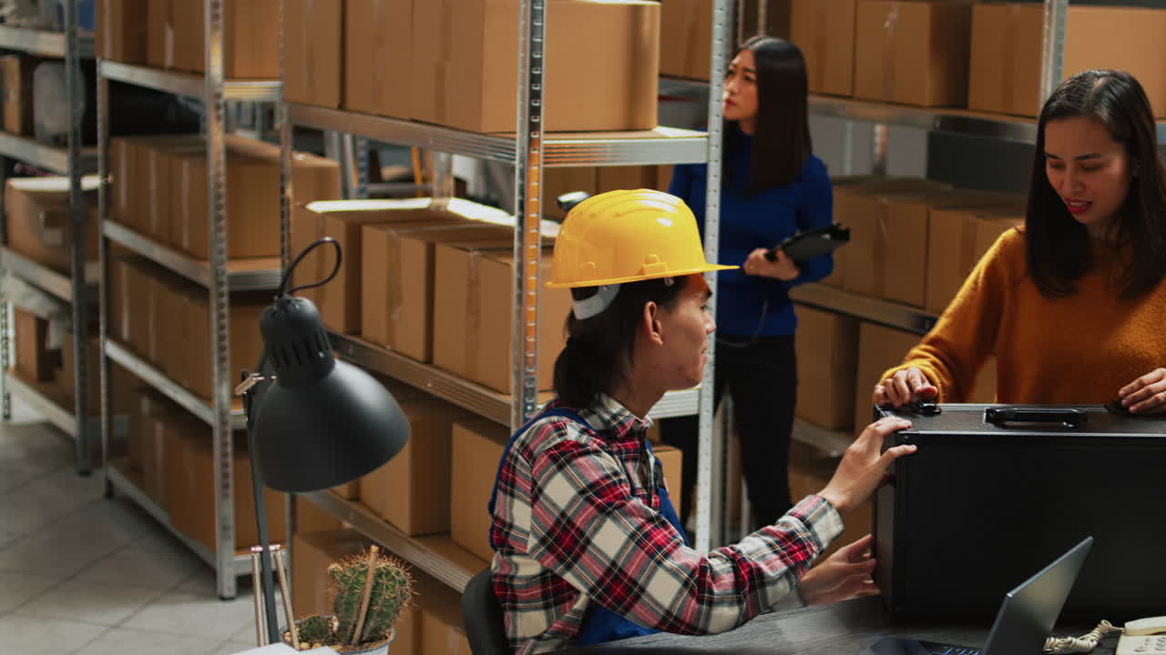 Warehouse workers managing inventory with technology