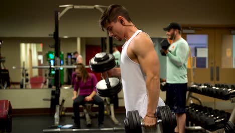 Young-bodybuilder-using-a-heavy-dumbbell-doing-hammer-curls