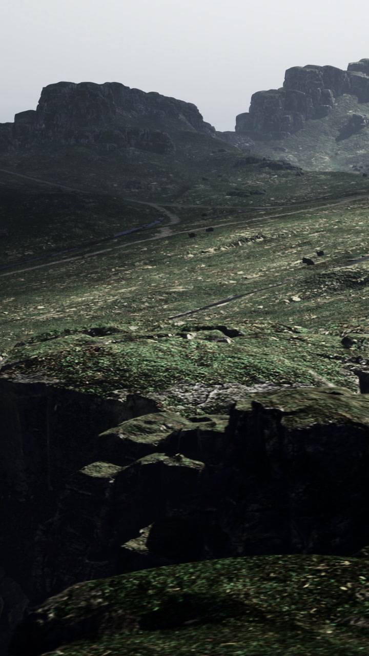 Views of rocky hills and a winding path in a misty landscape in the distance