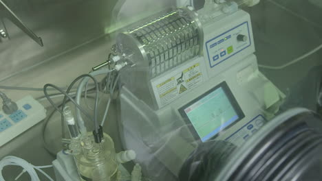 research laboratory worker conducting biological experiment with automated machinery. forensic exam in lab or pharma, genetics and innovation in medicine for detection of antibodies and infections