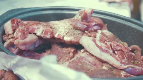 stacking uncooked beef seasoned ready to be cooked on barbeque