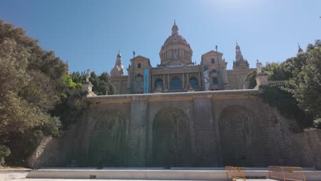 view of the historic museu nacional d'art de catalunya in barcelona, highlighted by its elegant architecture and lit by the bright sunshine on a beautiful day.