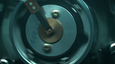 vhs video tape wrapping around the rotating head drum of the vcr - top view, interrogation room mood