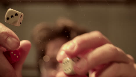 dice falling on a transparent surface from an underside view