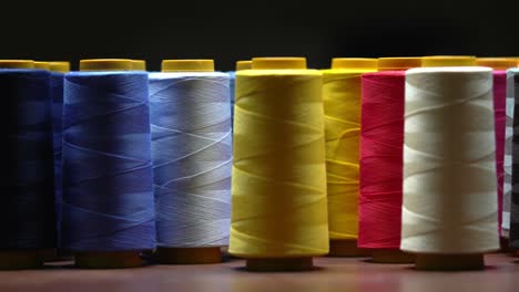 shot of colourful cotton thread spools inside a clothing manufacturing sweatshop