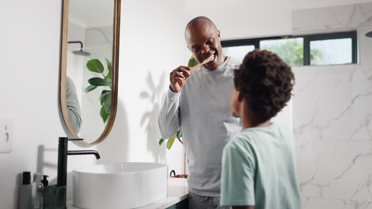 Father and son brushing teeth in bathroom