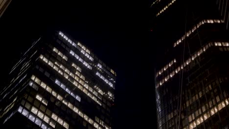 nighttime cityscape with illuminated office buildings and skyscrapers in frankfurt, germany
