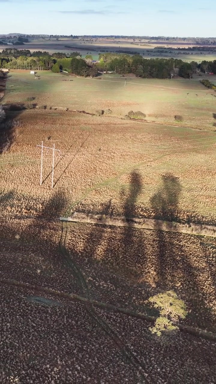 Drone shot of a countryside road and fields in Tenterfield, New South Wales, Australia.