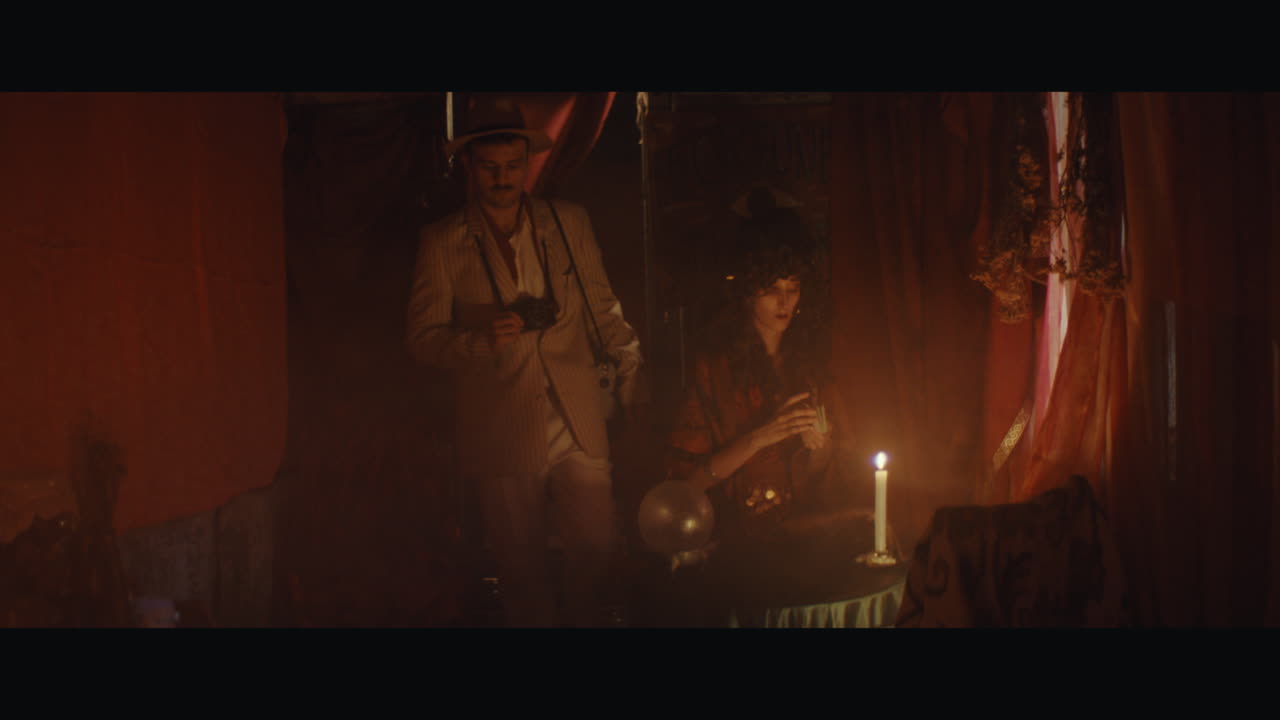 A man in hat goes inside the circus cart