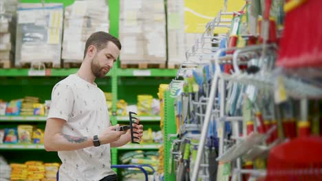 man shopping for garden tools in a home improvement store