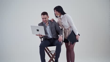 studio portrait of business couple. young business colleagues couple isolated over white wall background using laptop computer
