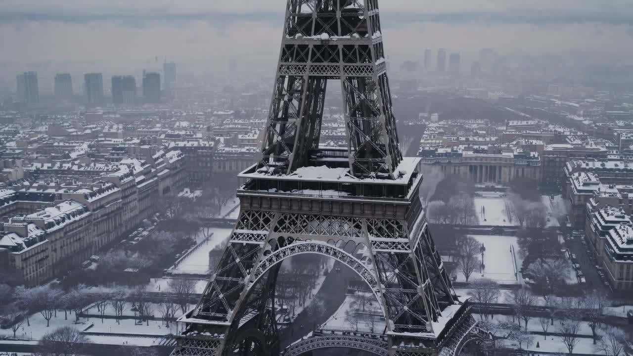 Aerial video captures the Eiffel Tower in winter, showcasing its snow-covered structure