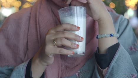 una mujer bebiendo un batido.