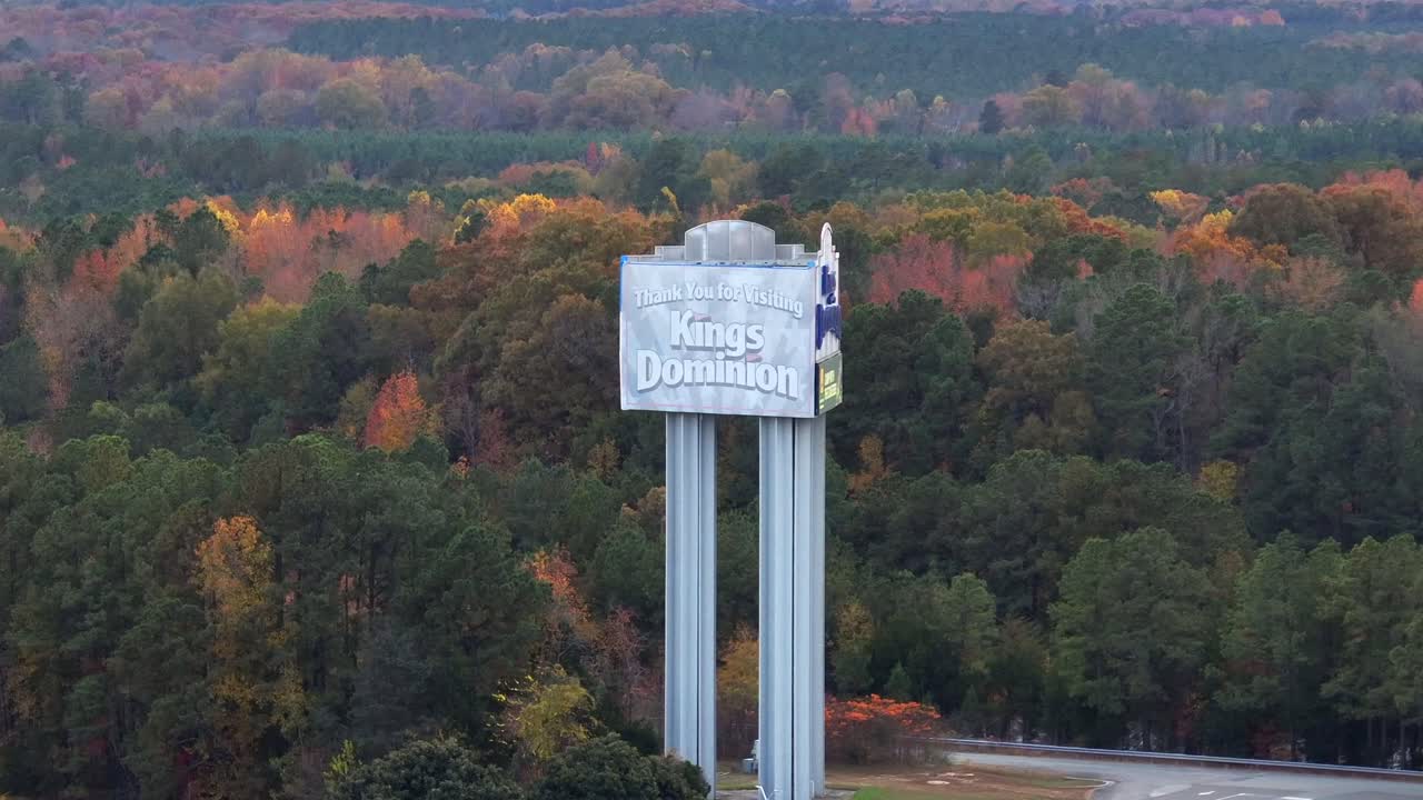 Thank you for visiting kings dominion amusement center in doswell, Virginia. Aerial view. Multi-colored trees on cloudy day in fall season. Wide shot
