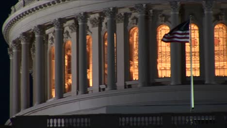 la cámara recorre lentamente la cúpula del capitolio iluminada por la noche