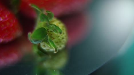 macro detailed video of a pile of strawberries, tiny green raw strawberry, on a rotating stand, smooth movement, slow motion 120fps