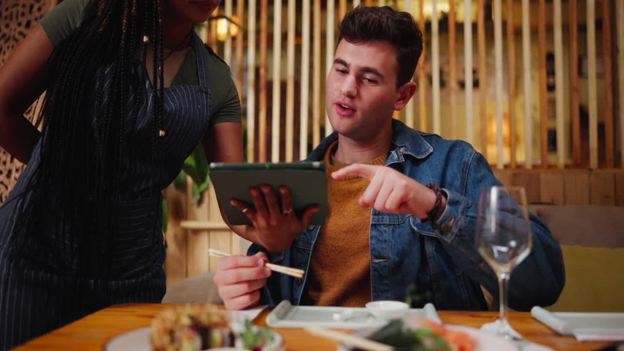 Customer Ordering Food with Tablet in Restaurant