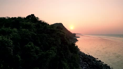 a stunning end of the day at mae nam viewpoint, koh samui, thailand, with the sun setting over lush green hills and the tranquil sea