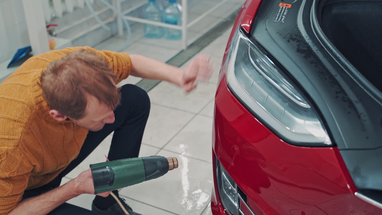 Master for sticking films. Worker at the service station is further processed edge vinyl special dryer