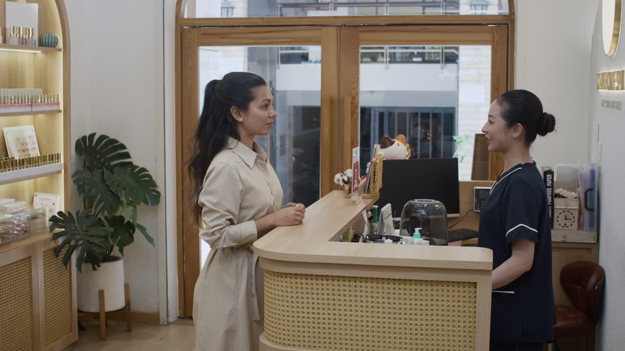 Female Client Getting Tray with Towels before Procedures at Spa Salon