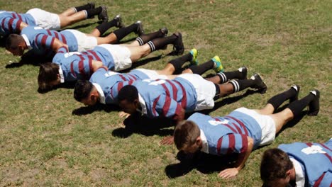 Rugby-players-doing-push-ups-in-the-field-4K-4k