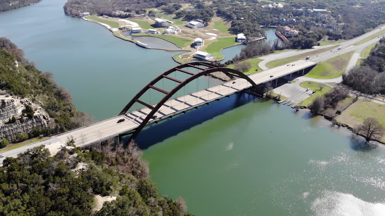 Aerial Austin Pennybacker Bridge - moving left showing bridge overlook areas with large part of river and roadway in view