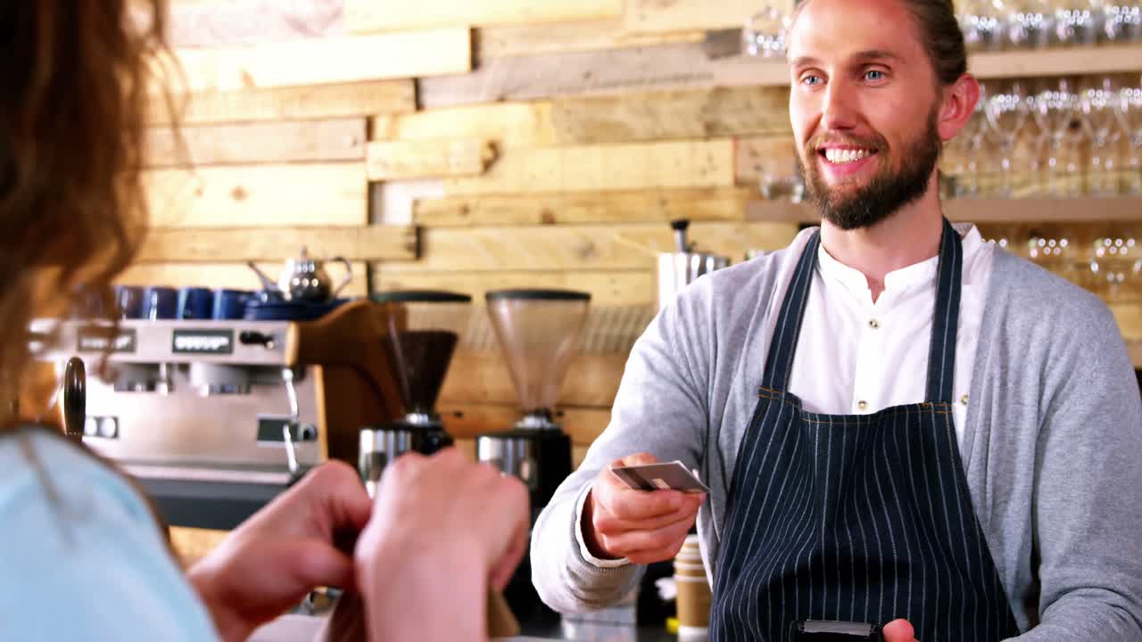 cliente que realiza un pago a través de un terminal de pago en el mostrador