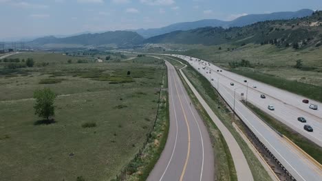 a drone shot of a busy highway and bike path