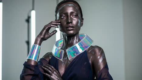 a striking model poses dramatically in a futuristic setting featuring iridescent jewelry and metallic body art, creating an impression of elegance and modernity