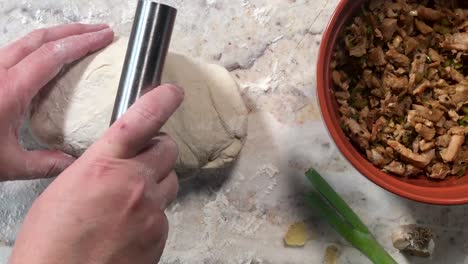 making steamed buns by preparing and cutting dough for stuffing